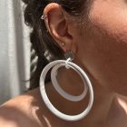 Minimalist earrings crafted from spotlight parts, featuring large metal circles in sleek black or white for a bold, modern look.