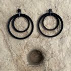 Minimalist earrings crafted from spotlight parts, featuring large metal circles in sleek black or white for a bold, modern look.